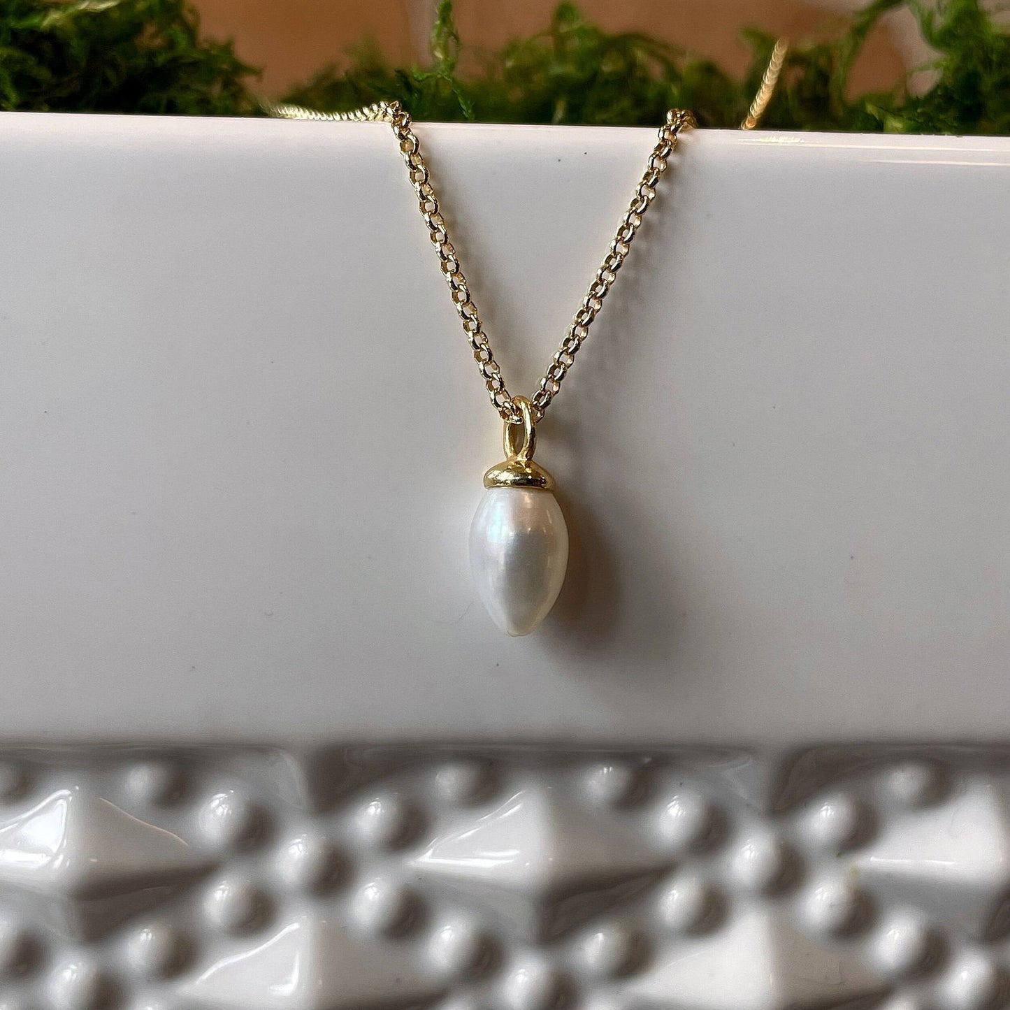 Photo of "Pendulum" pendant in a decorative scene, designed by , available at Plumb Gold & Plumb Silver