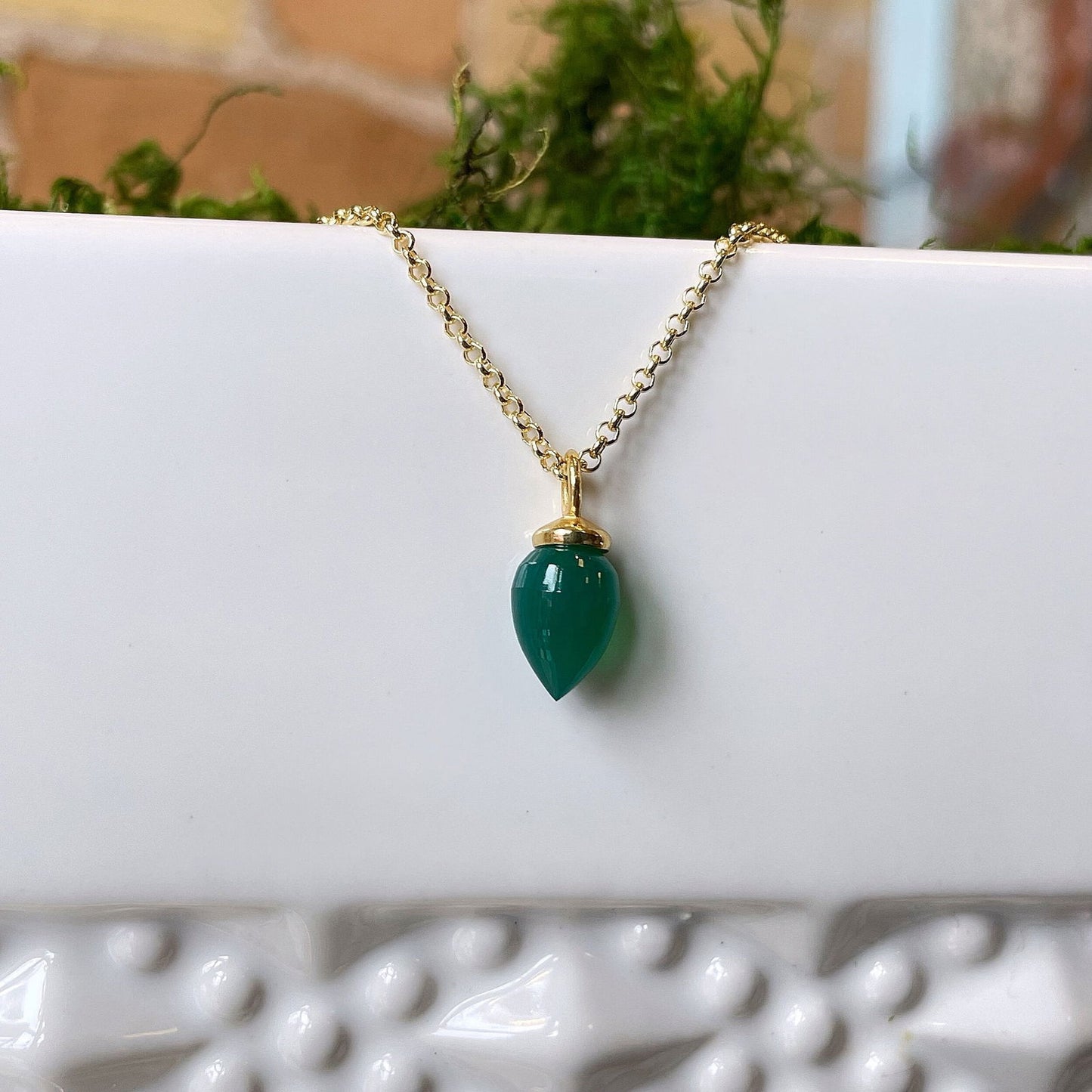 Photo of "Pendulum" pendant in a decorative scene, designed by , available at Plumb Gold & Plumb Silver