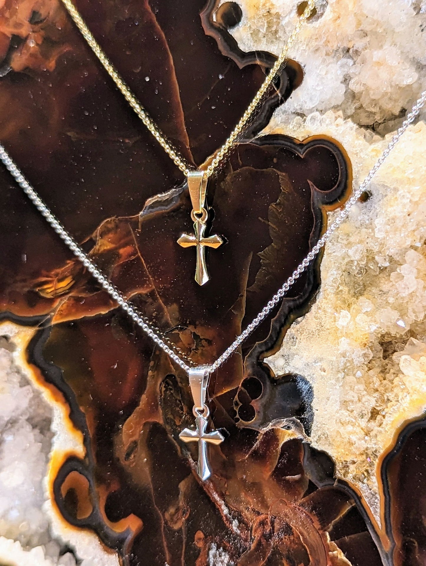 Photo of Petite Cross Necklace in a decorative scene, designed by , available at Plumb Gold & Plumb Silver