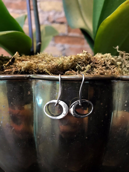 Photo of "Petite Elliptical" Earrings in a decorative scene, designed by , available at Plumb Gold & Plumb Silver