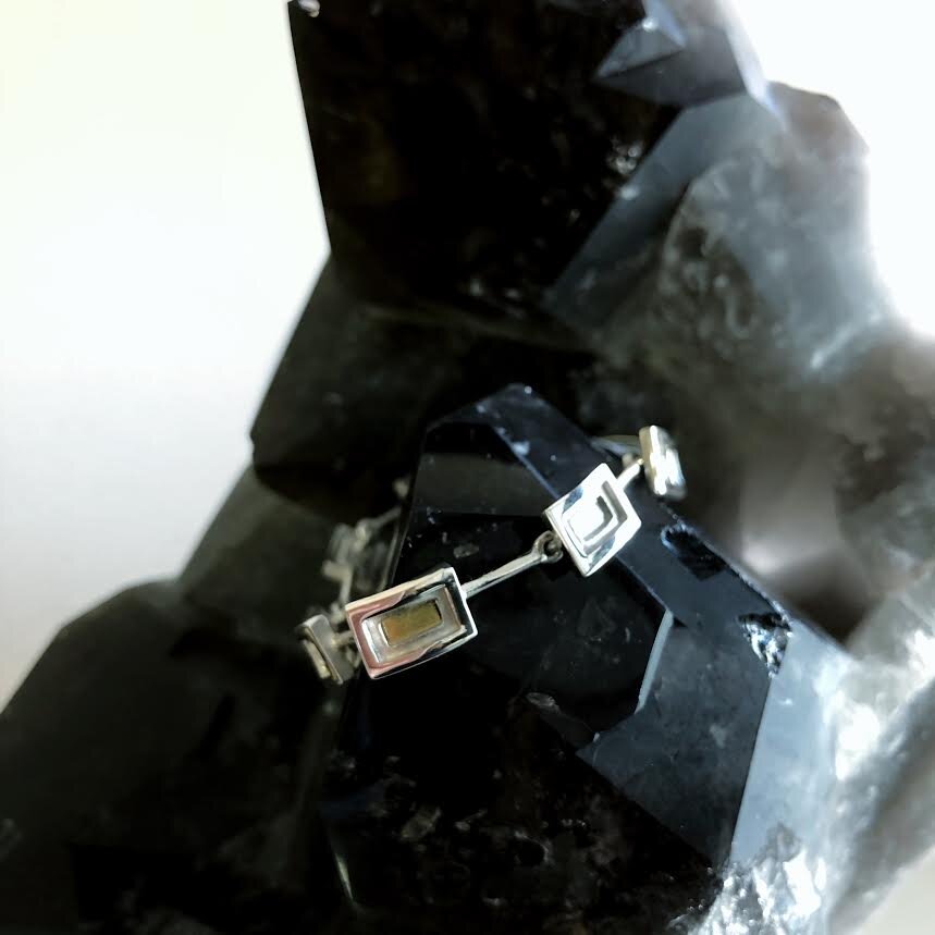 Photo of Petite Rectangle Link Bracelet in a decorative scene, designed by , available at Plumb Gold & Plumb Silver