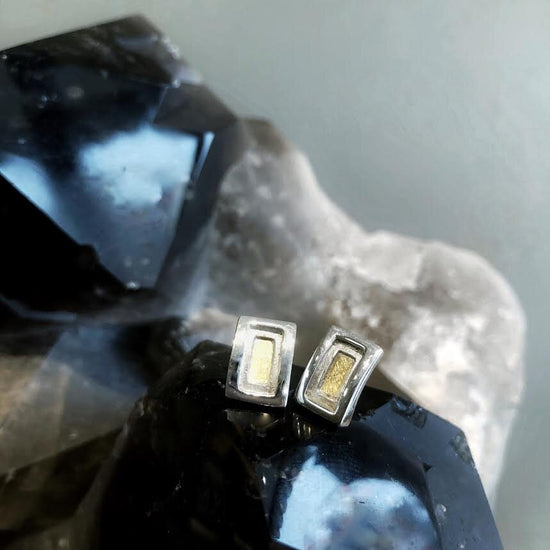 Photo of Petite Rectangle Stud Earrings in a decorative scene, designed by , available at Plumb Gold & Plumb Silver