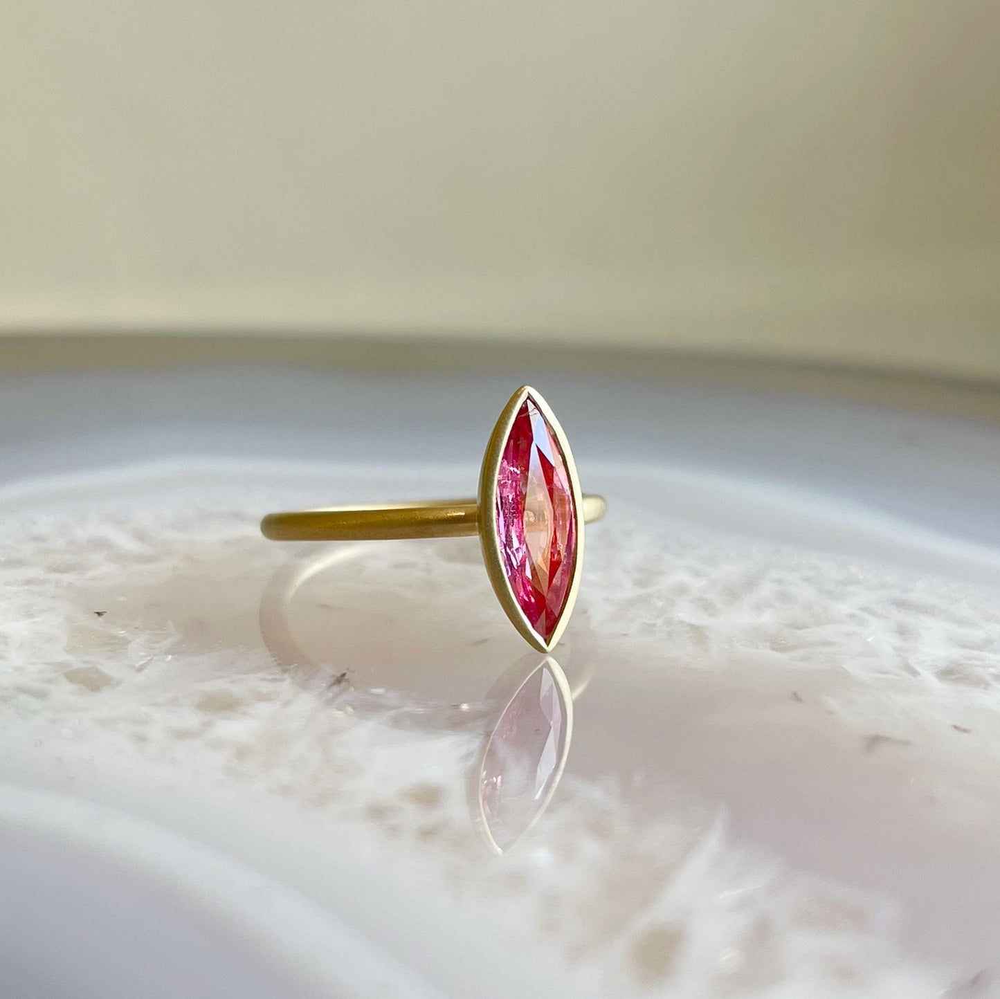 Photo of Pink Spinel Yumdrop in a decorative scene, designed by , available at Plumb Gold & Plumb Silver