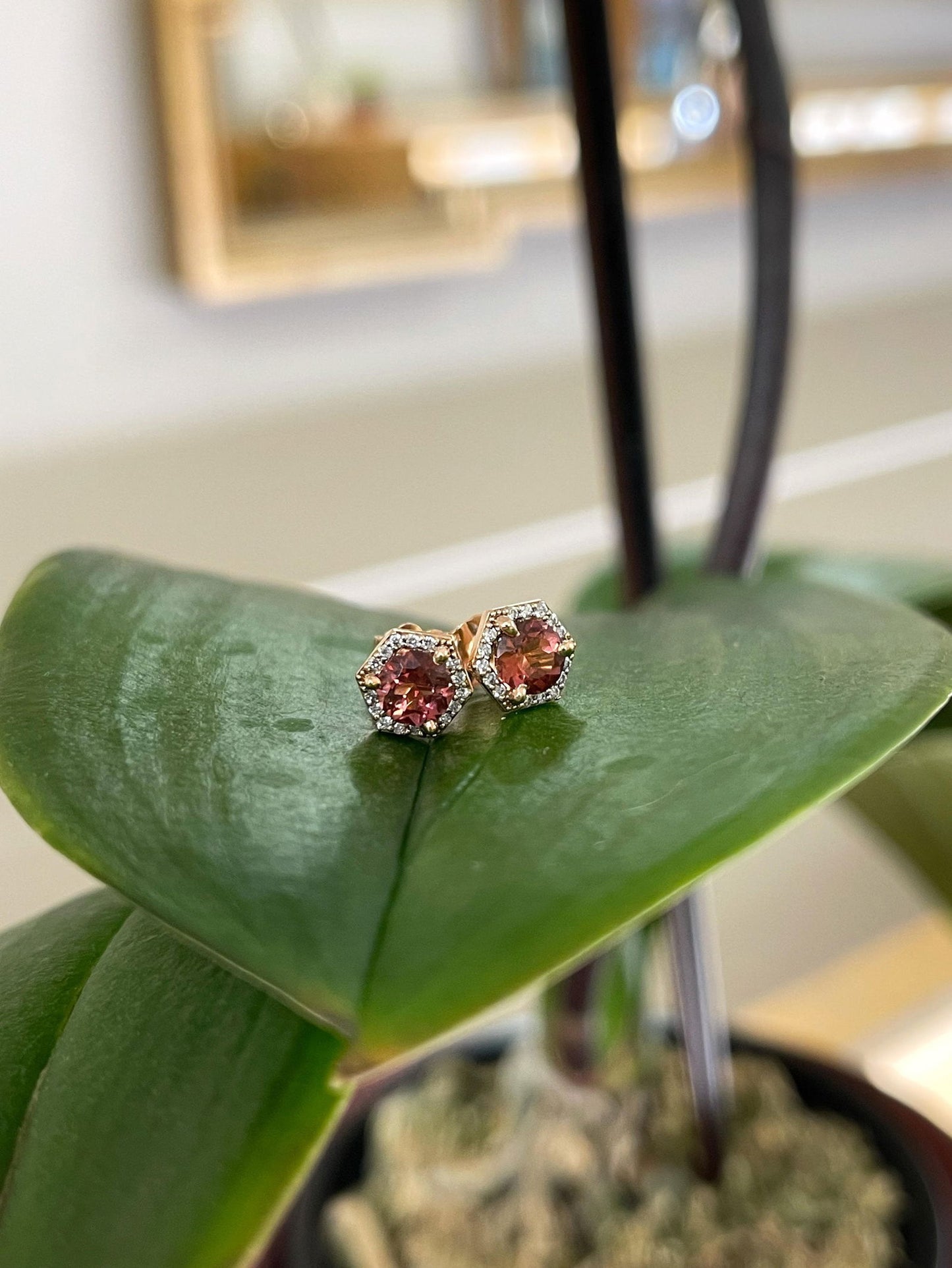 Photo of Pink Tourmaline Hexagon Studs in a decorative scene, designed by , available at Plumb Gold & Plumb Silver