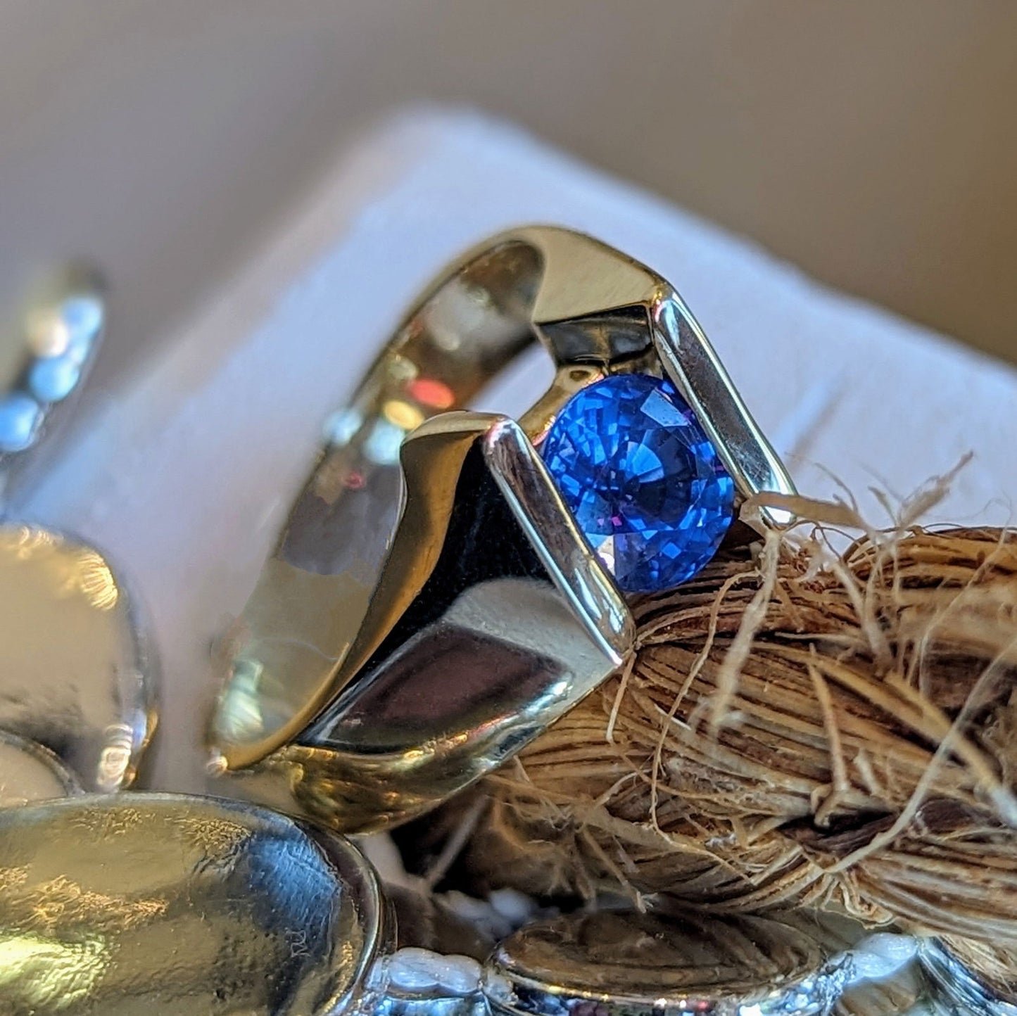 Photo of Plumb Gold Original Blue Sapphire Ring in a decorative scene, designed by , available at Plumb Gold & Plumb Silver
