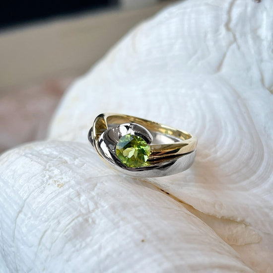 Photo of Plumb Gold Original Peridot Ring in a decorative scene, designed by , available at Plumb Gold & Plumb Silver