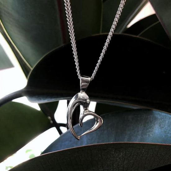 Photo of Plumb Silver Original Asymmetrical Heart Pendant in a decorative scene, designed by , available at Plumb Gold & Plumb Silver