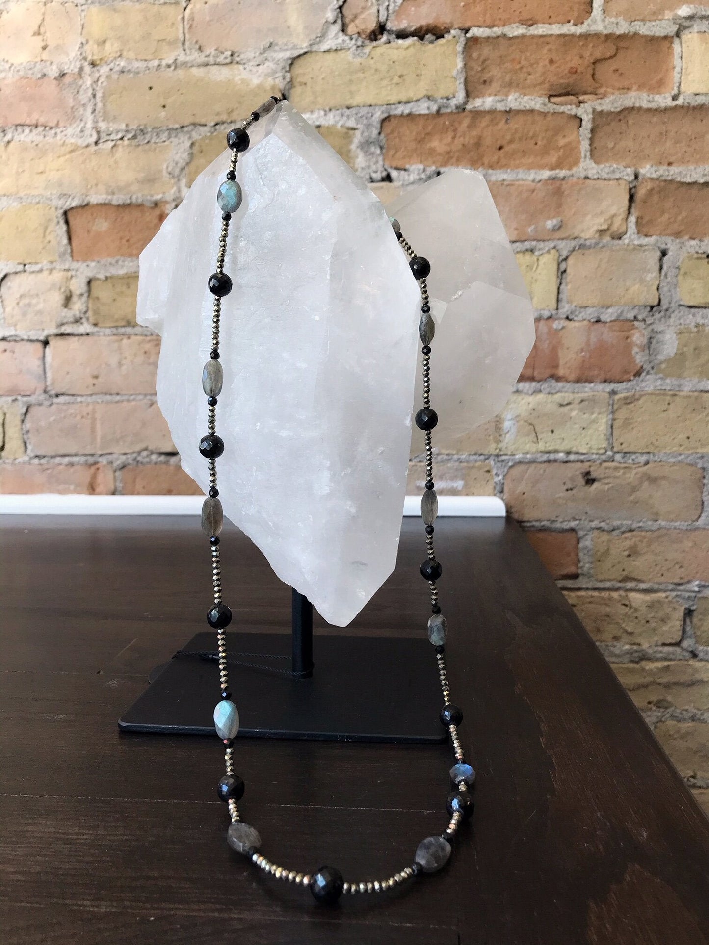 Photo of Plumb Silver Original Labradorite, Pyrite, and Black Spinel Necklace in a decorative scene, designed by , available at Plumb Gold & Plumb Silver