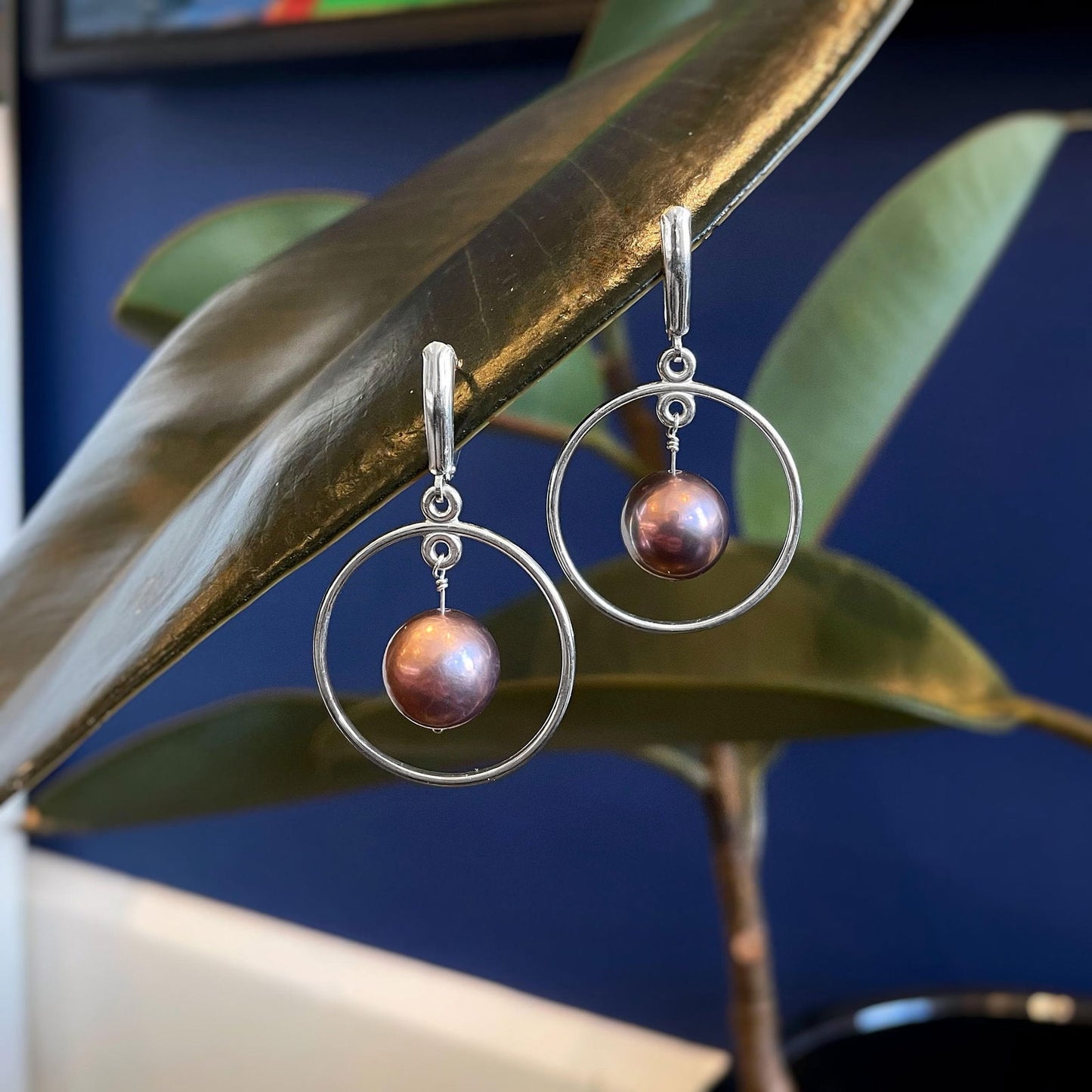 Photo of Plumb Silver Original Pearl Dangles in a decorative scene, designed by , available at Plumb Gold & Plumb Silver