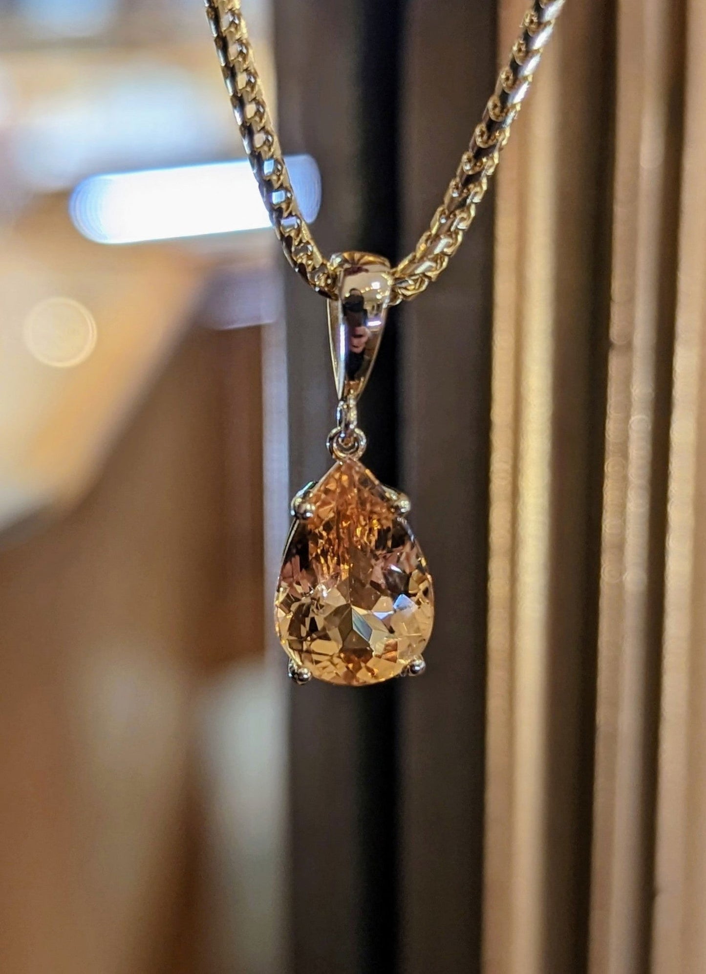 Photo of Precious Topaz Pendant in a decorative scene, designed by , available at Plumb Gold & Plumb Silver
