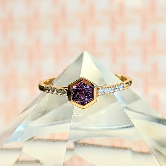 Photo of Purple Sapphire Hexagon Stackable Ring in a decorative scene, designed by , available at Plumb Gold & Plumb Silver