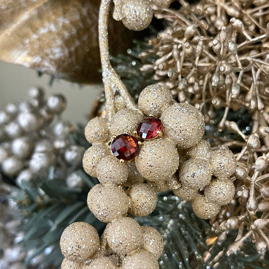 Photo of Red Garnet Studs in a decorative scene, designed by , available at Plumb Gold & Plumb Silver