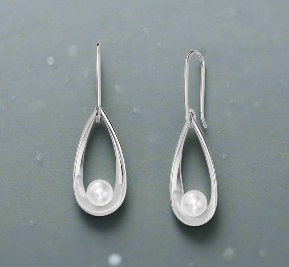 Photo of "Rendezvous" Earring in a decorative scene, designed by , available at Plumb Gold & Plumb Silver