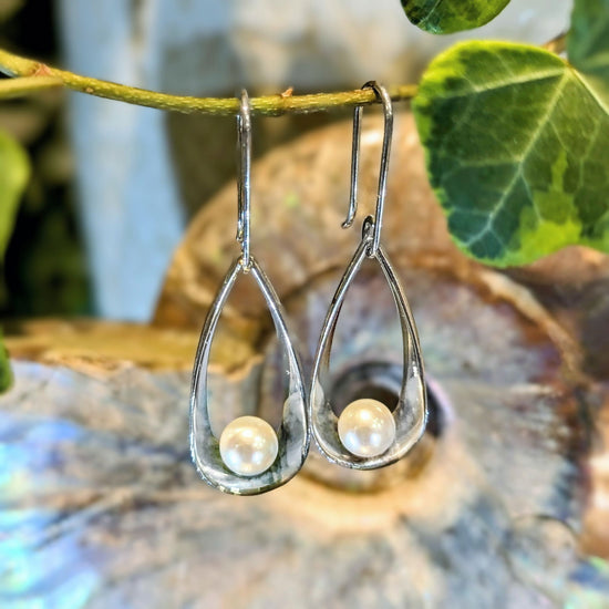 Photo of "Rendezvous" Earring in a decorative scene, designed by , available at Plumb Gold & Plumb Silver