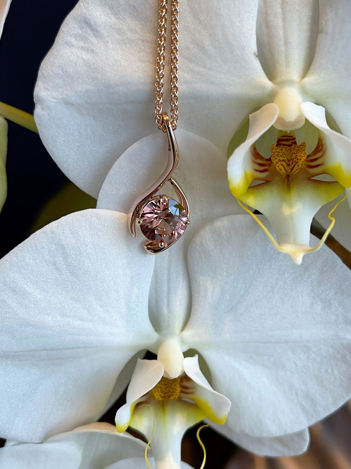 Photo of Rose Zircon Pendant in a decorative scene, designed by , available at Plumb Gold & Plumb Silver