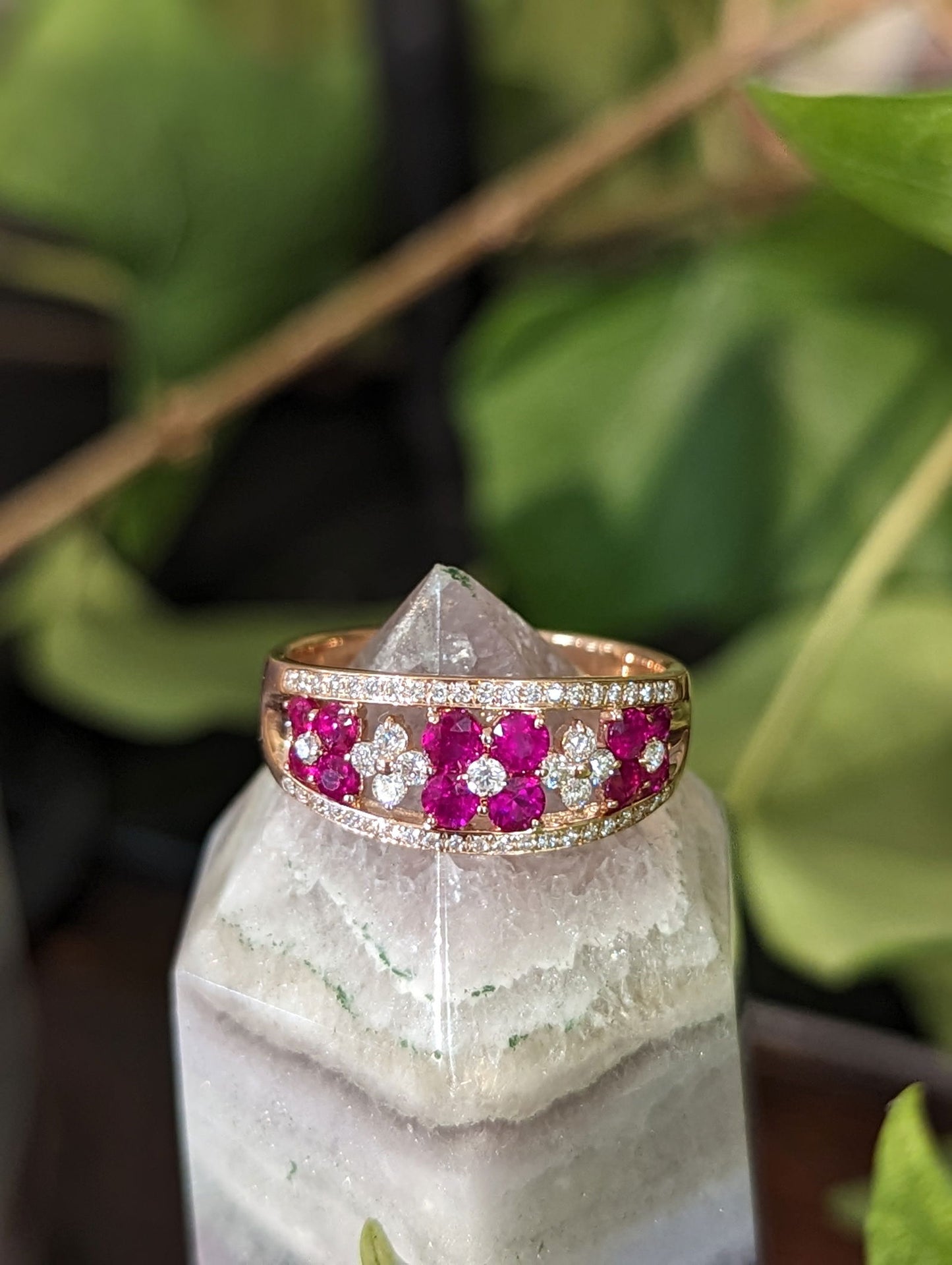 Photo of Ruby Flower Ring in a decorative scene, designed by , available at Plumb Gold & Plumb Silver