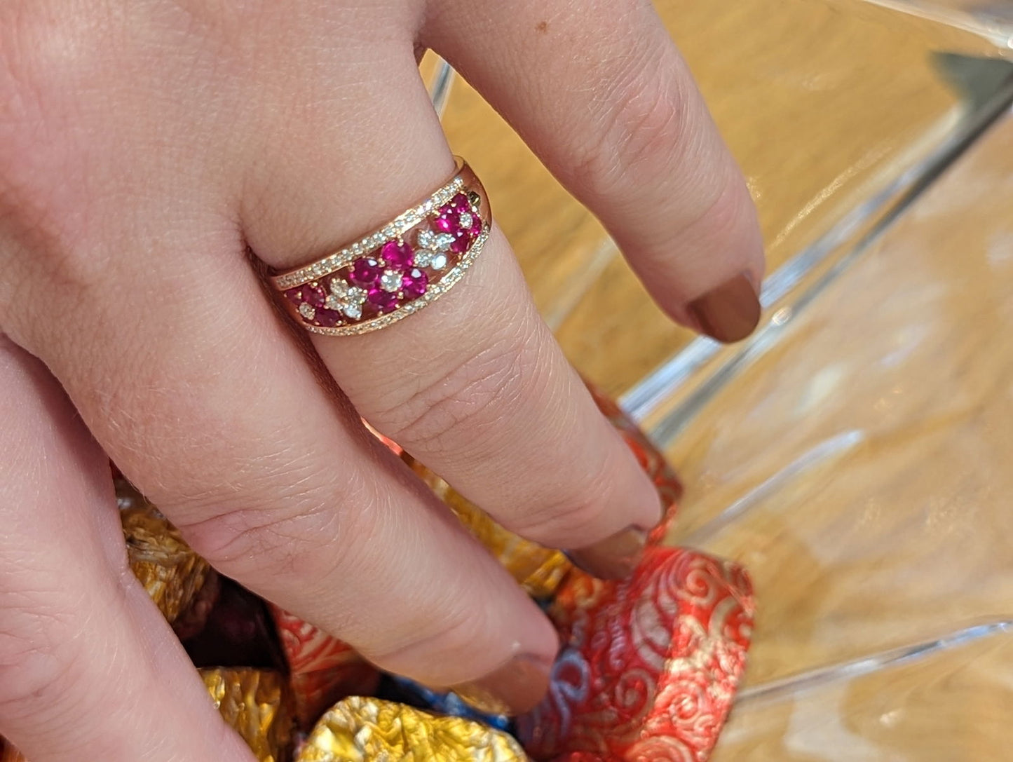 Photo of Ruby Flower Ring in a decorative scene, designed by , available at Plumb Gold & Plumb Silver