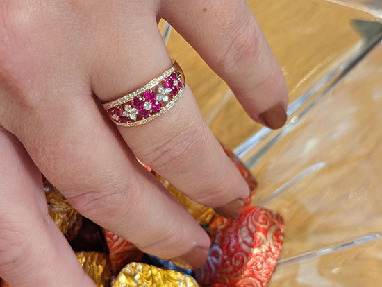Photo of Ruby Flower Ring in a decorative scene, designed by , available at Plumb Gold & Plumb Silver