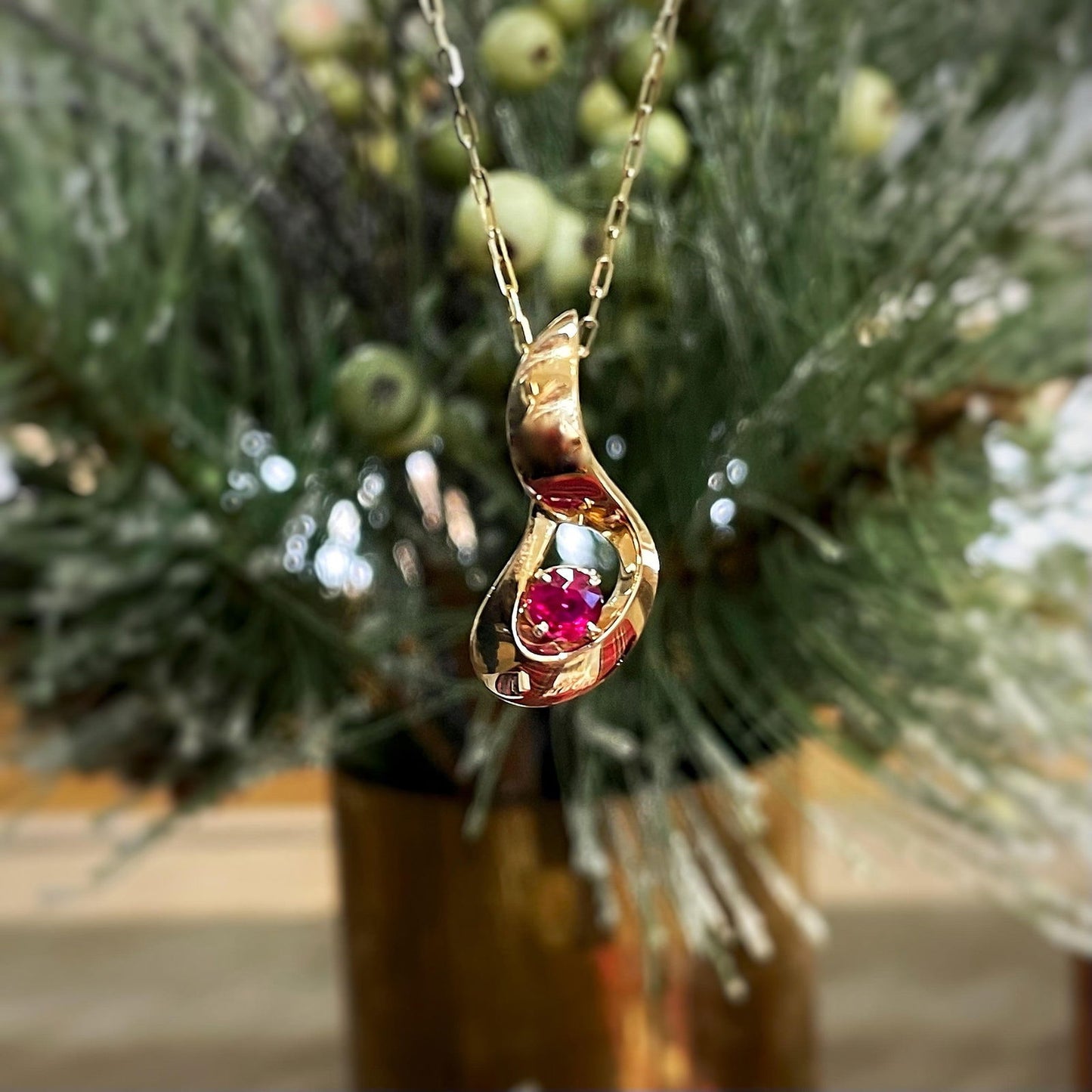 Photo of Ruby Pendant in a decorative scene, designed by , available at Plumb Gold & Plumb Silver