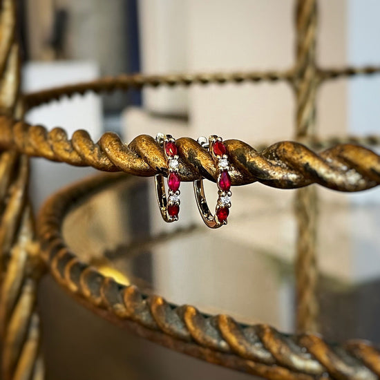 Photo of Ruby and Diamond Hoops in a decorative scene, designed by , available at Plumb Gold & Plumb Silver