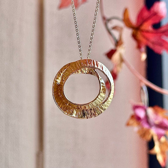 Photo of "Seaweed" Pendant in a decorative scene, designed by -, available at Plumb Gold & Plumb Silver