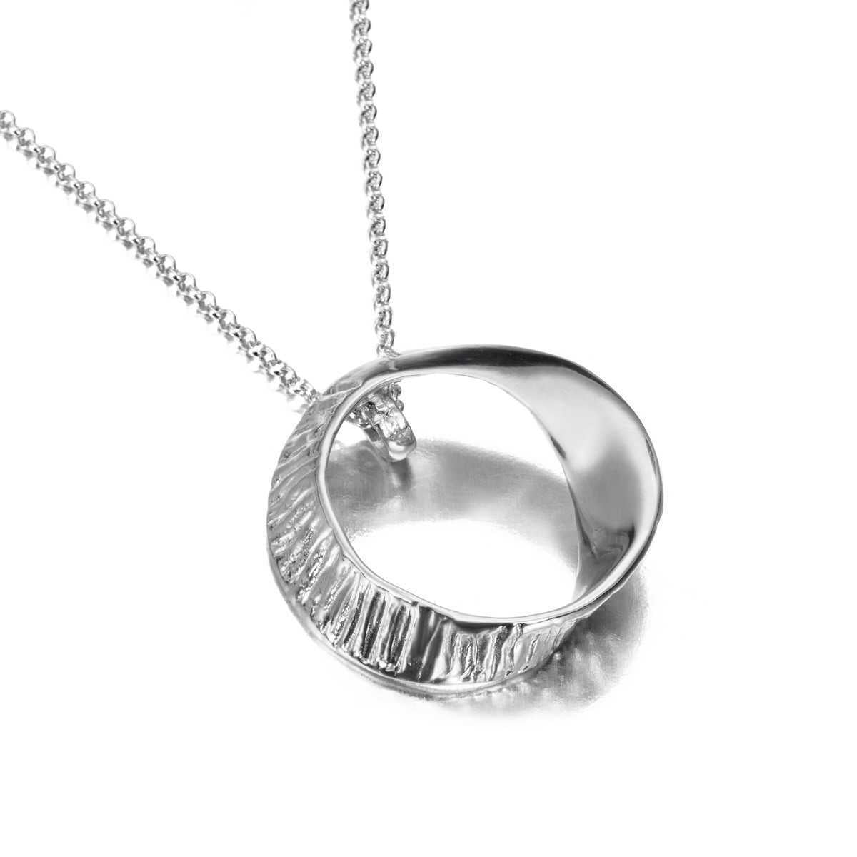 Photo of Seaweed Pendant in a decorative scene, designed by -, available at Plumb Gold & Plumb Silver
