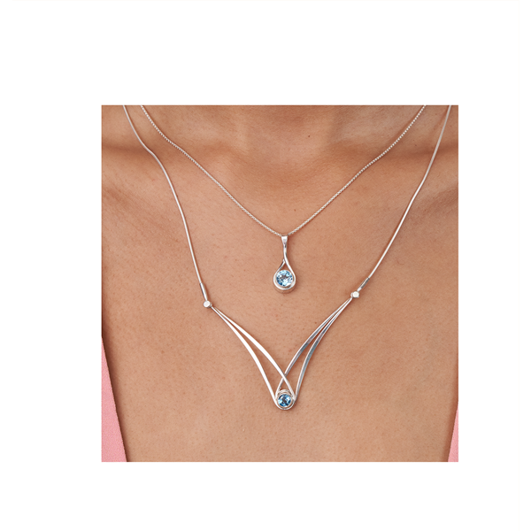 Photo of "Sensational Swing" Necklace in a decorative scene, designed by , available at Plumb Gold & Plumb Silver