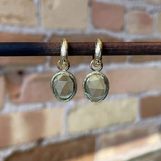Photo of “Shade” Green Quartz Dangles in a decorative scene, designed by , available at Plumb Gold & Plumb Silver