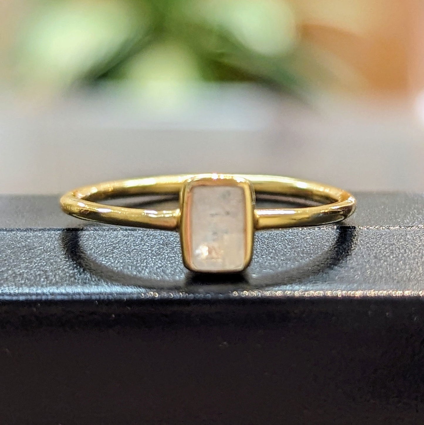 Photo of "Shade" Ring in a decorative scene, designed by , available at Plumb Gold & Plumb Silver