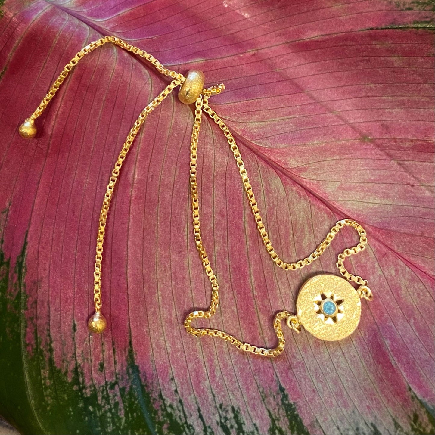 Photo of Shine Bolero Chain Bracelet in a decorative scene, designed by -, available at Plumb Gold & Plumb Silver