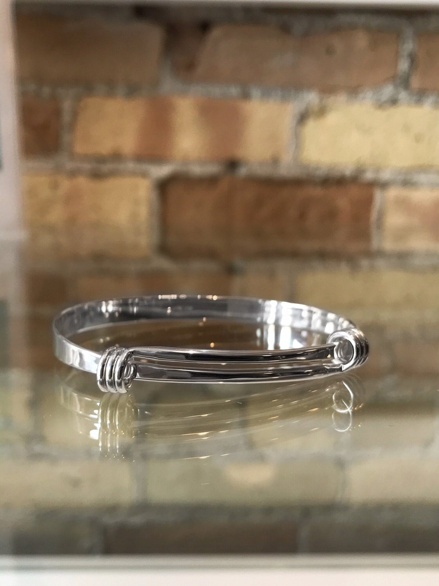 Photo of "Signature" Bracelet in a decorative scene, designed by , available at Plumb Gold & Plumb Silver