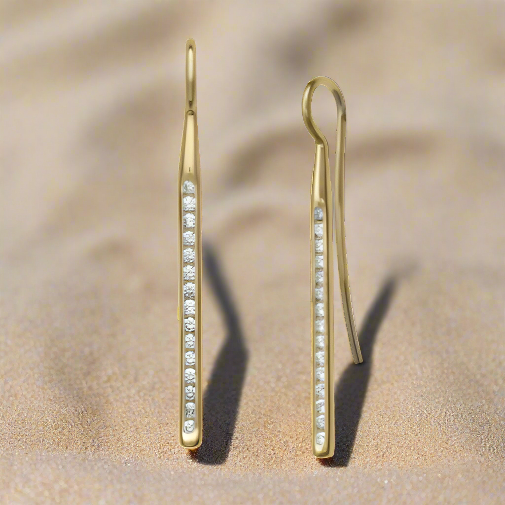 Photo of "Sparkler" Diamond Earrings in a decorative scene, designed by , available at Plumb Gold & Plumb Silver