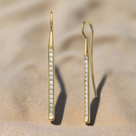 Photo of "Sparkler" Diamond Earrings in a decorative scene, designed by , available at Plumb Gold & Plumb Silver