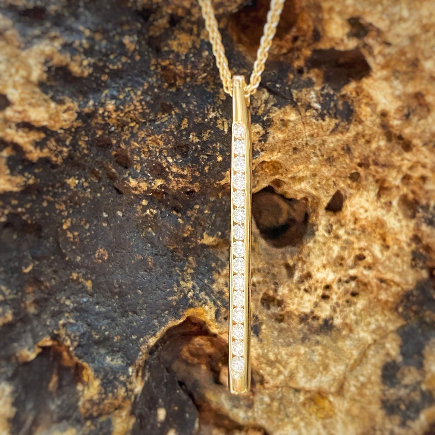Photo of "Sparkler" Diamond Pendant in a decorative scene, designed by , available at Plumb Gold & Plumb Silver