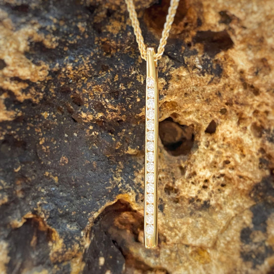 Photo of "Sparkler" Diamond Pendant in a decorative scene, designed by , available at Plumb Gold & Plumb Silver