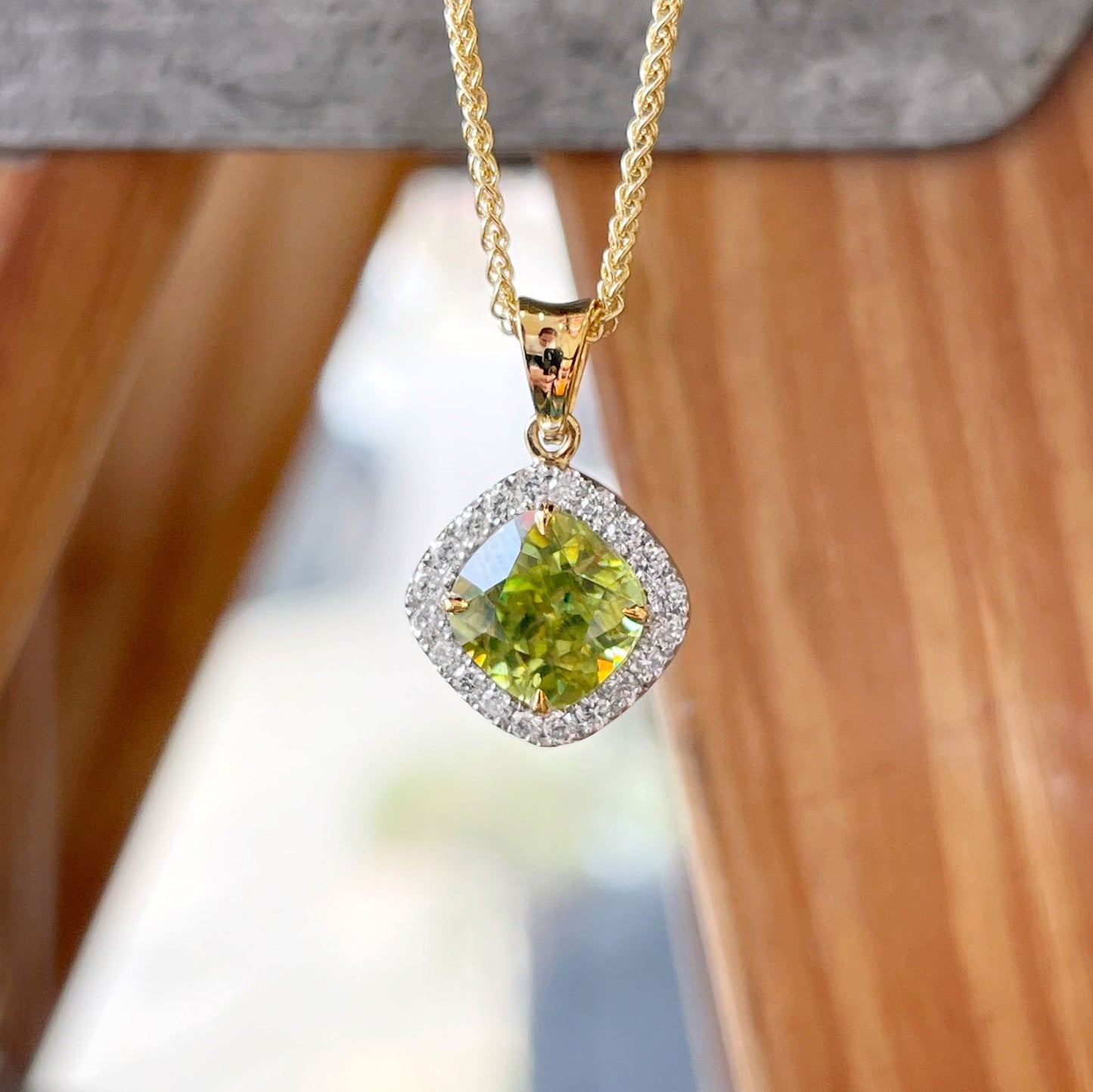 Photo of Sphene Diamond Pendant in a decorative scene, designed by , available at Plumb Gold & Plumb Silver