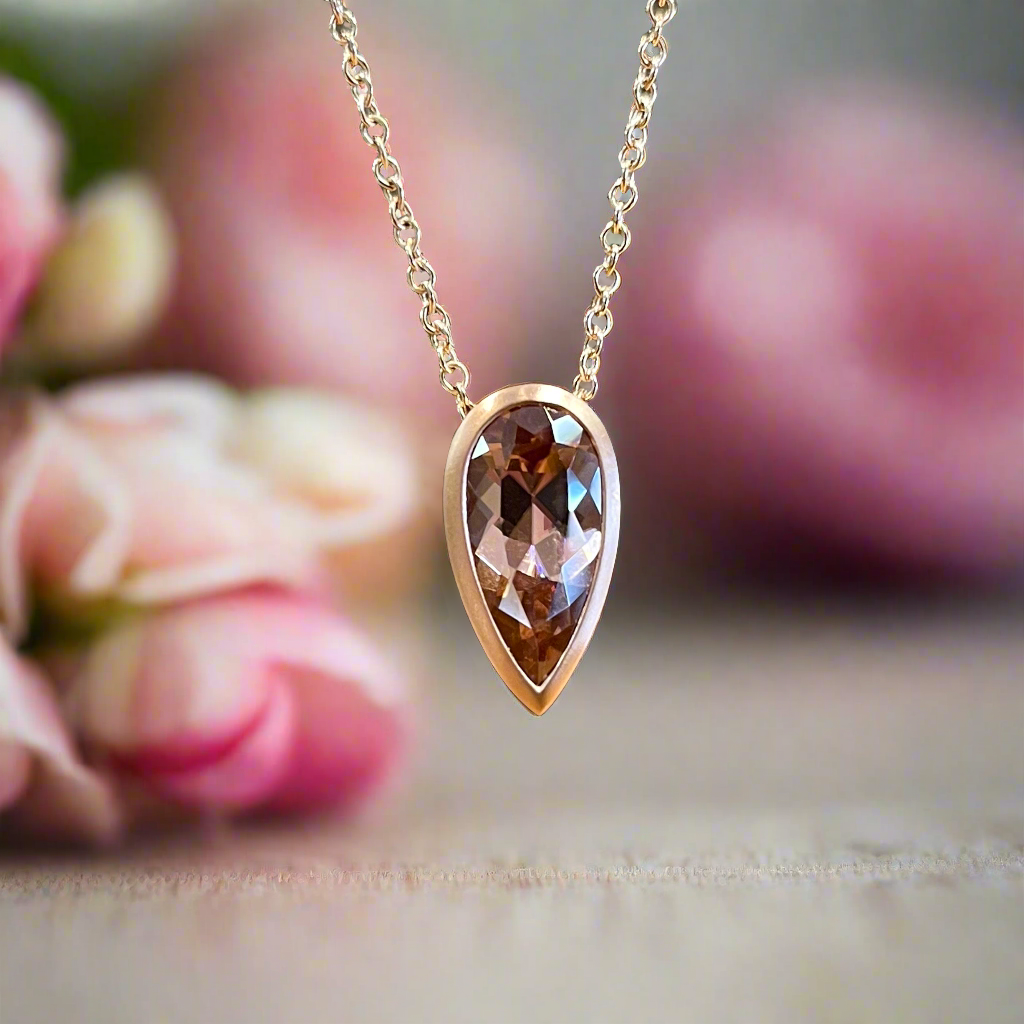 Photo of Spice Zircon Necklace in a decorative scene, designed by , available at Plumb Gold & Plumb Silver