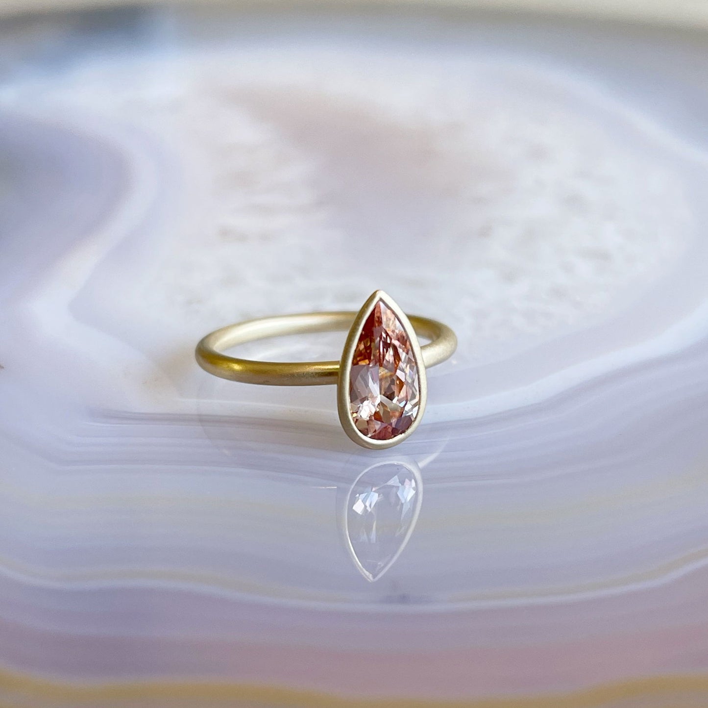 Photo of Spice Zircon Yumdrop in a decorative scene, designed by , available at Plumb Gold & Plumb Silver