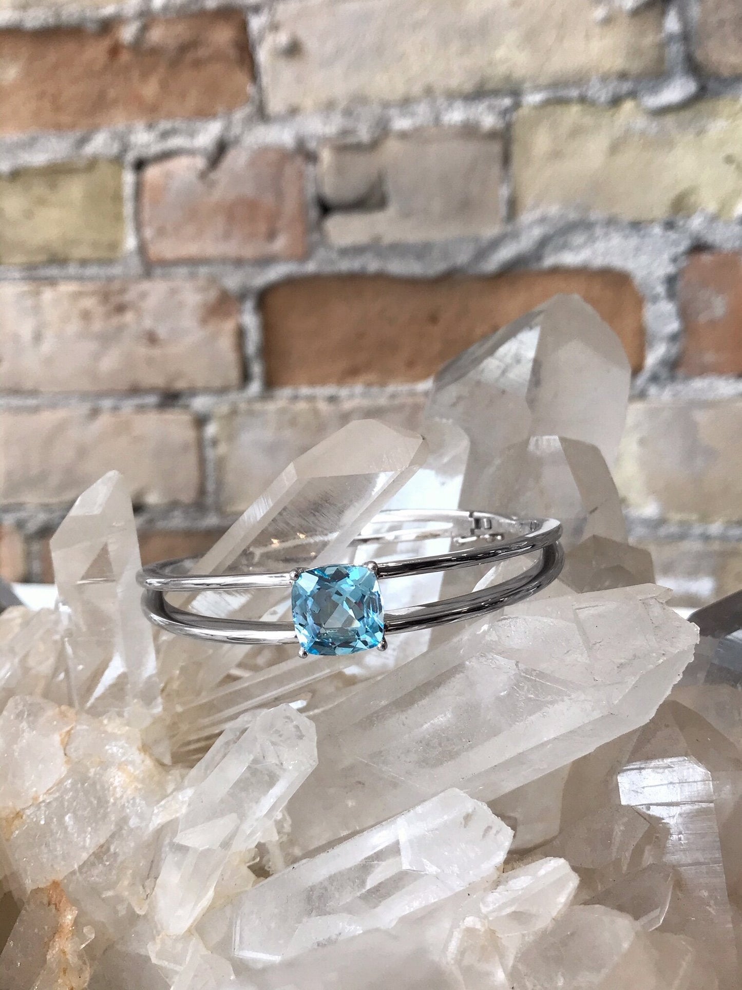 Photo of Split Bar Bangle in a decorative scene, designed by , available at Plumb Gold & Plumb Silver