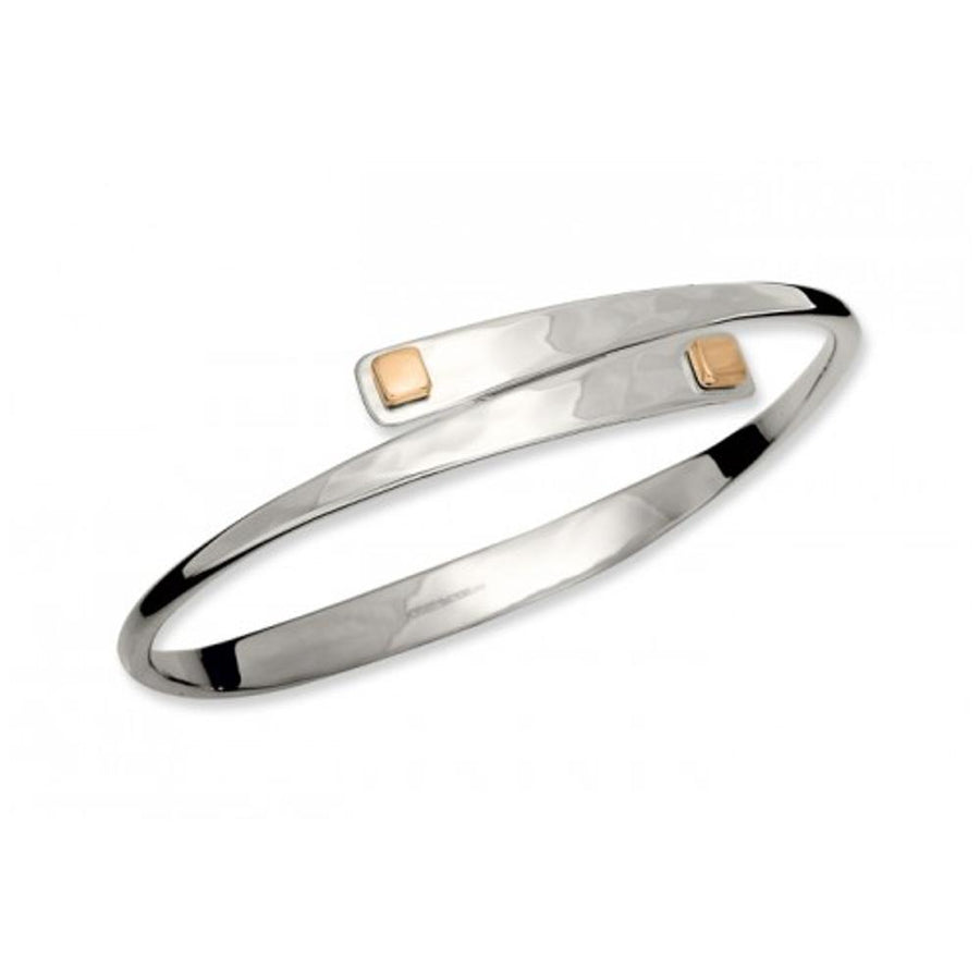 Photo of "Square Swing" Bangle in a decorative scene, designed by , available at Plumb Gold & Plumb Silver
