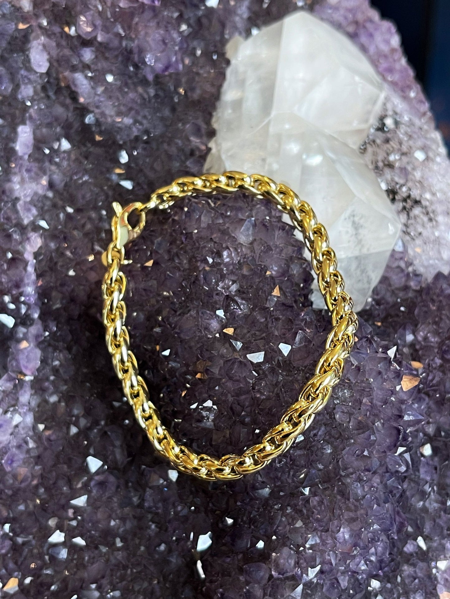 Photo of Squared Twist Bracelet in a decorative scene, designed by , available at Plumb Gold & Plumb Silver