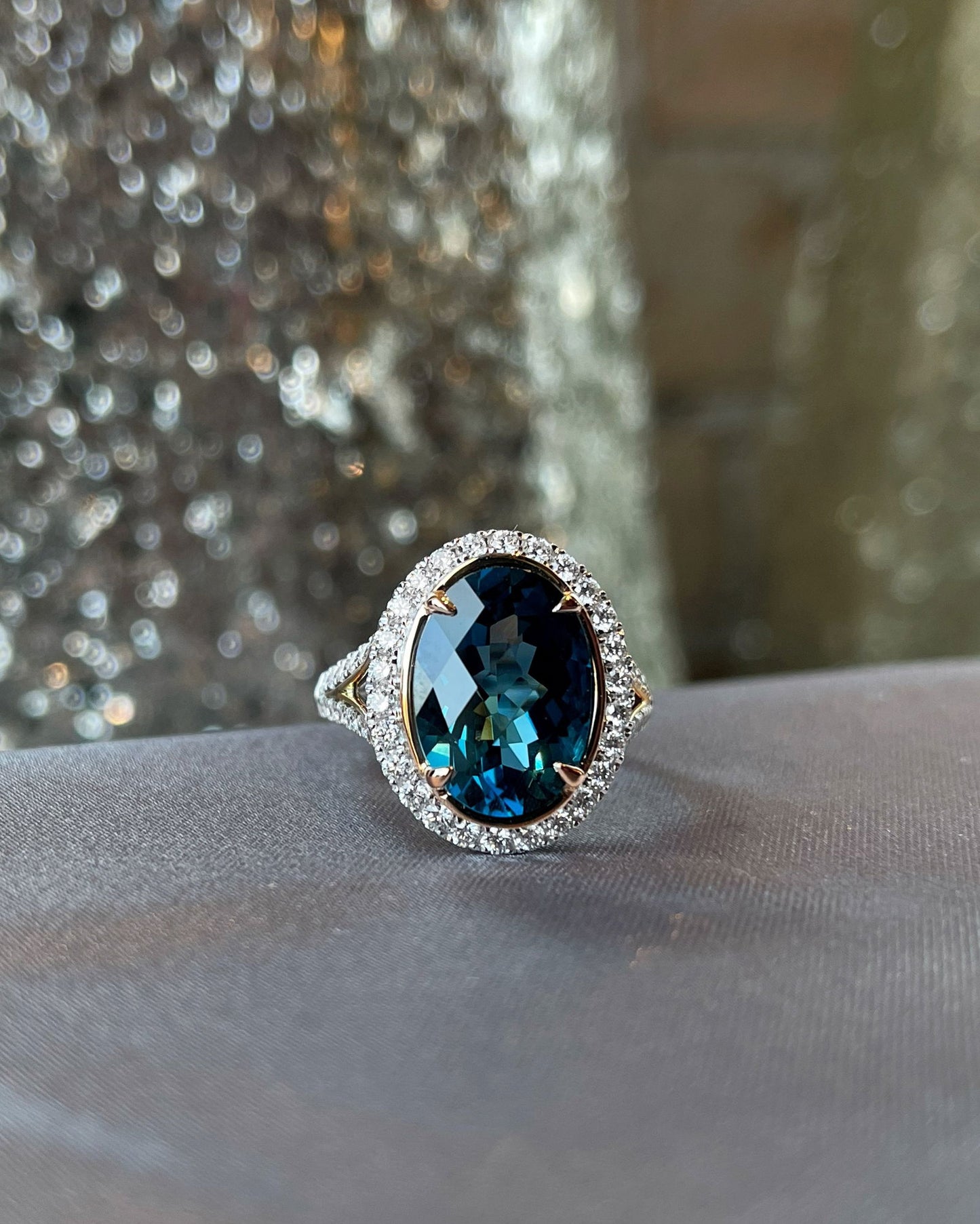 Photo of Stanton Color London Blue Topaz and Diamond Ring in a decorative scene, designed by , available at Plumb Gold & Plumb Silver