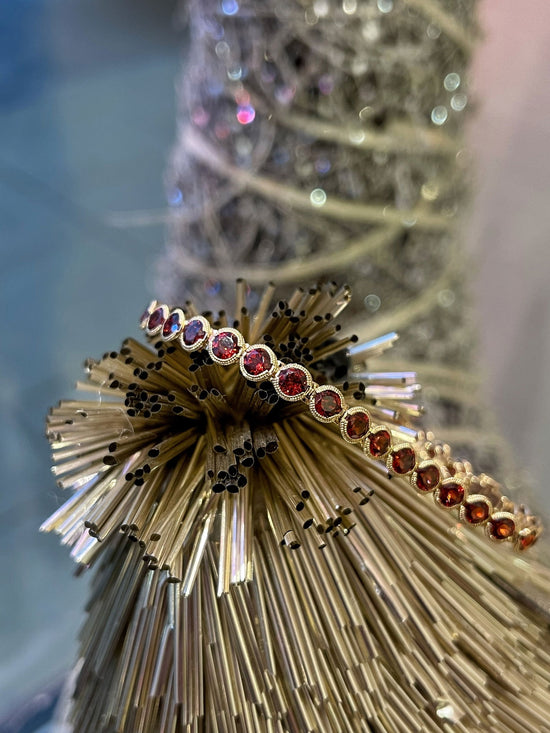 Photo of Stanton Color Red Garnet Bracelet in a decorative scene, designed by , available at Plumb Gold & Plumb Silver