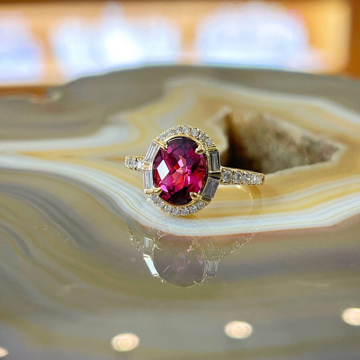 Photo of Stanton Color Rhodolite Garnet Ring in a decorative scene, designed by , available at Plumb Gold & Plumb Silver