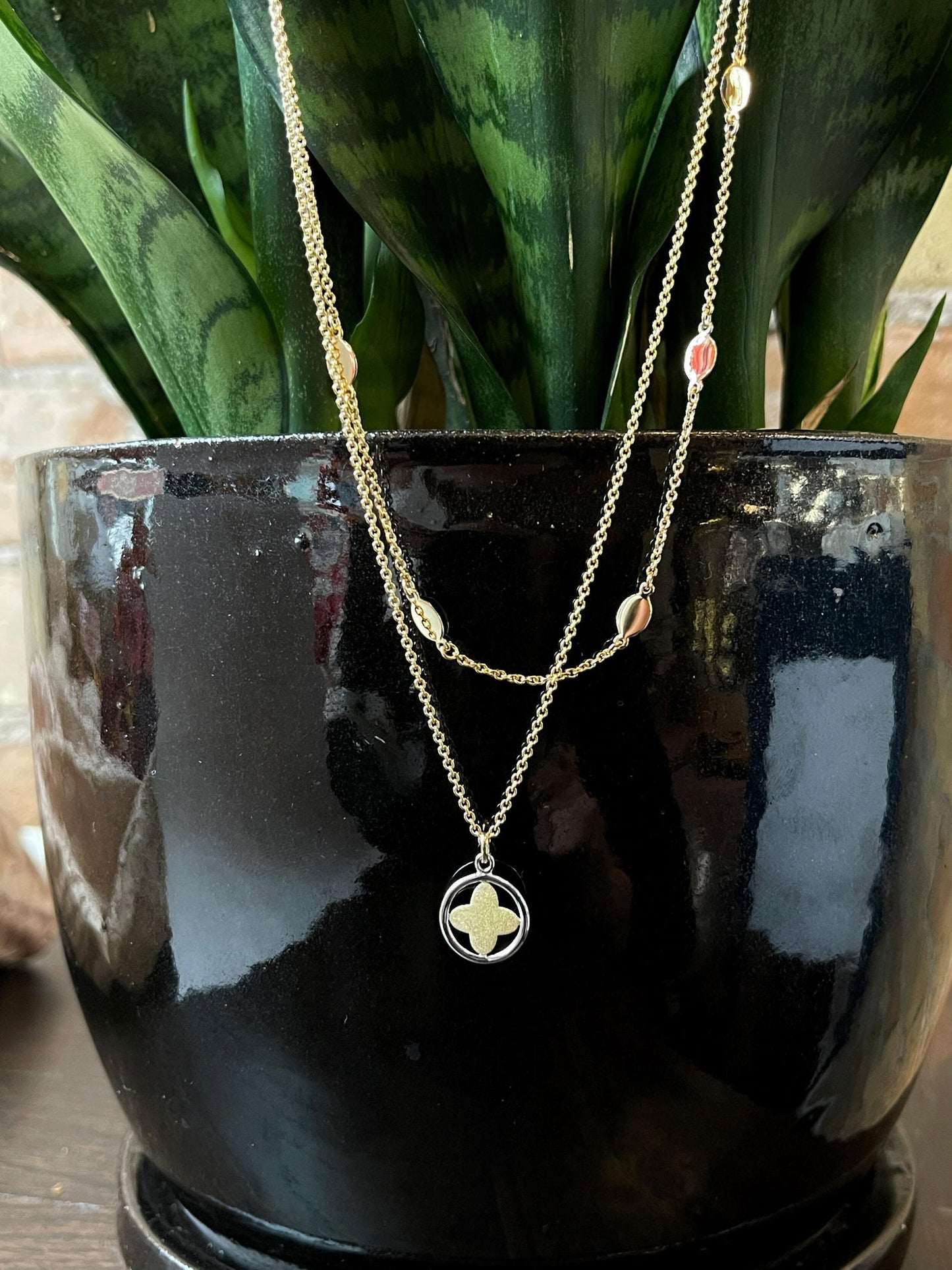 Photo of Star Layered Necklace in a decorative scene, designed by , available at Plumb Gold & Plumb Silver