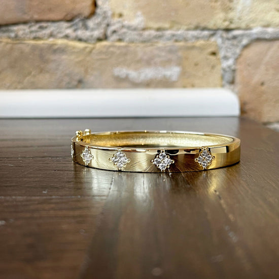 Photo of Starburst Bangle in a decorative scene, designed by , available at Plumb Gold & Plumb Silver