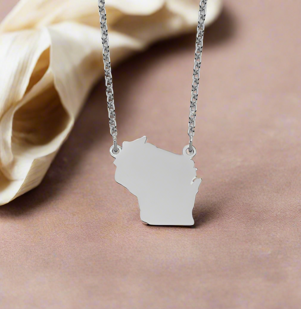 Photo of Sterling Silver Wisconsin Necklace in a decorative scene, designed by , available at Plumb Gold & Plumb Silver