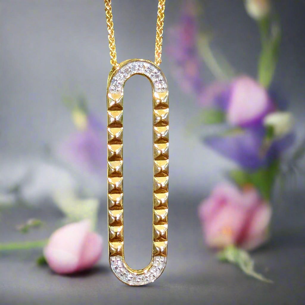 Photo of Studded Oval Pendant in a decorative scene, designed by , available at Plumb Gold & Plumb Silver