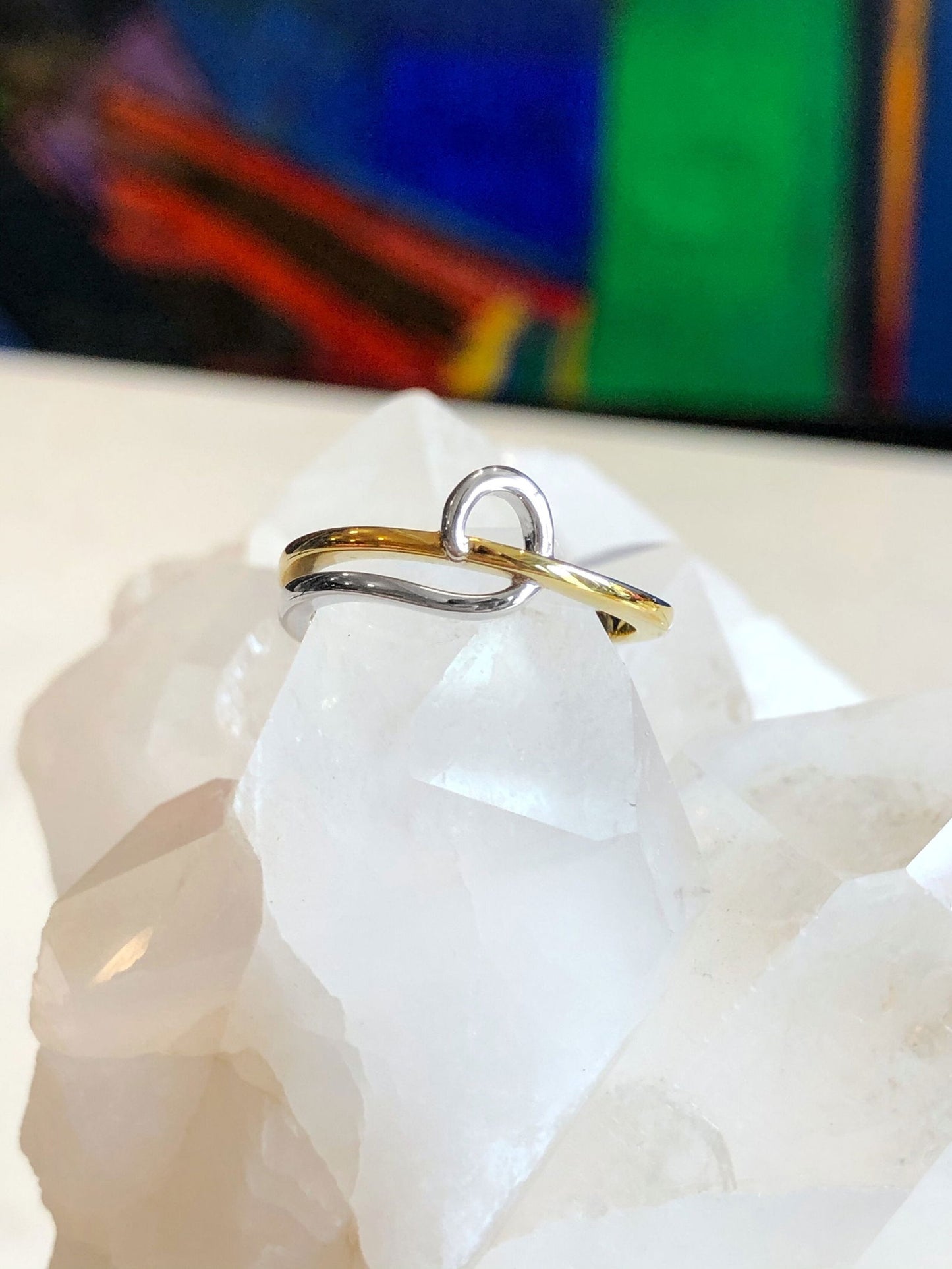 Photo of Swirl Ring in a decorative scene, designed by , available at Plumb Gold & Plumb Silver
