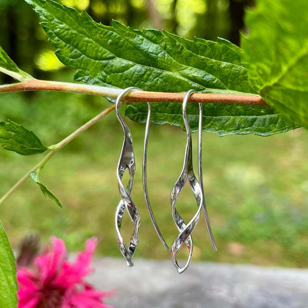 Photo of Swizzle Earrings in a decorative scene, designed by , available at Plumb Gold & Plumb Silver